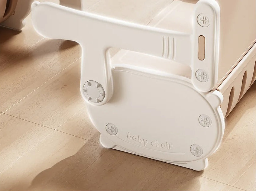 White baby chair on a wooden floor